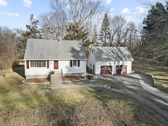 view of front facade with a garage and a front lawn