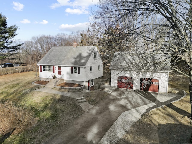 view of front of property with a garage and a front lawn