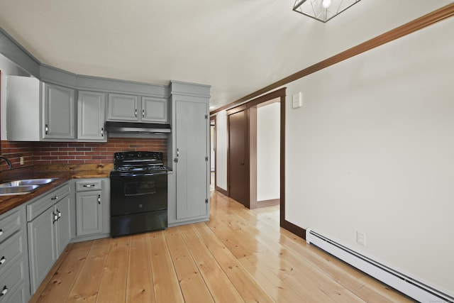 kitchen featuring decorative backsplash, sink, a baseboard radiator, gray cabinets, and black / electric stove