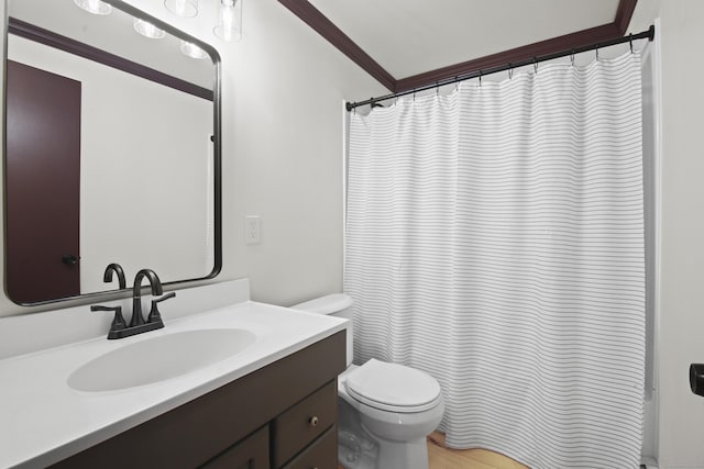 bathroom with vanity, toilet, and ornamental molding