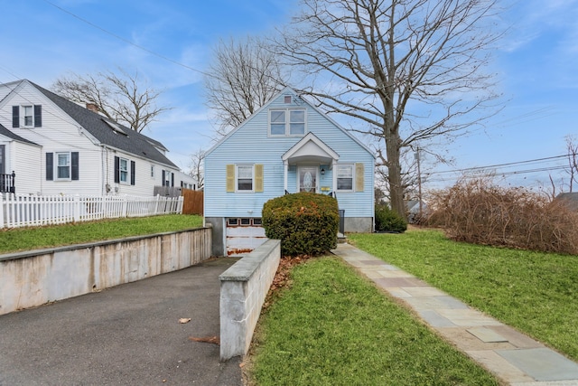 view of front facade with a front yard and a garage