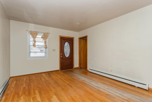 foyer with baseboard heating and light hardwood / wood-style floors