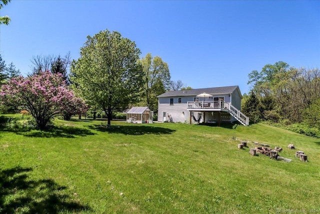 view of yard featuring a wooden deck and an outbuilding