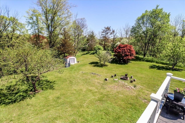 view of yard with a shed and a fire pit