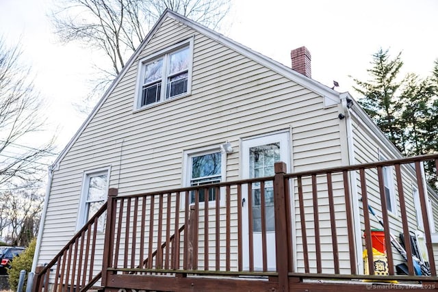 view of side of home with a wooden deck