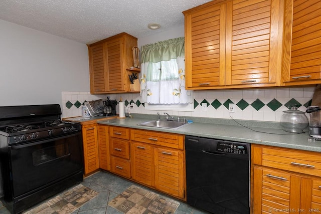 kitchen featuring decorative backsplash, a textured ceiling, sink, black appliances, and dark tile patterned flooring