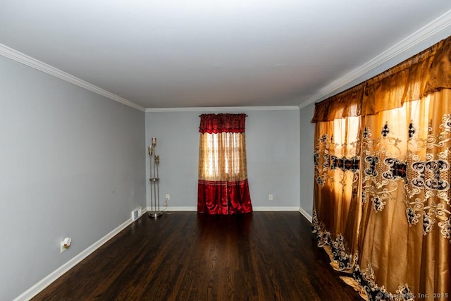 empty room featuring crown molding and dark wood-type flooring