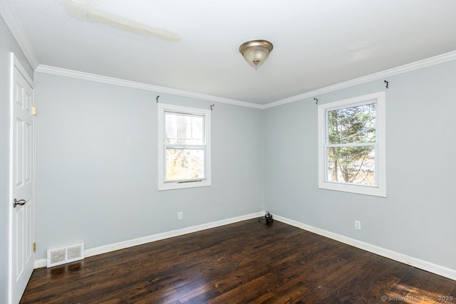 spare room with dark hardwood / wood-style floors and crown molding