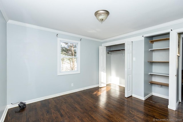 unfurnished bedroom with dark hardwood / wood-style floors, ornamental molding, and a closet