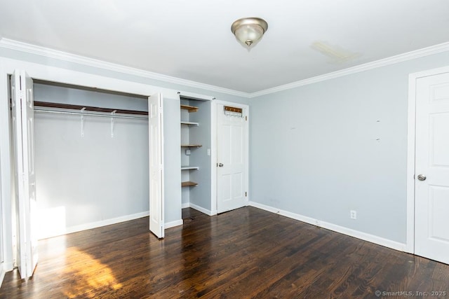 unfurnished bedroom featuring dark wood-type flooring, a closet, and ornamental molding