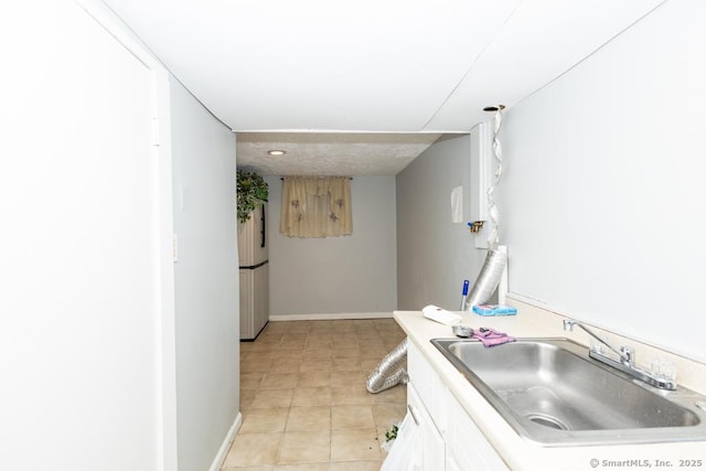 kitchen featuring white cabinets and sink