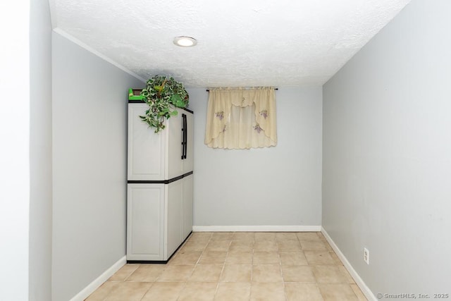 unfurnished room with a textured ceiling