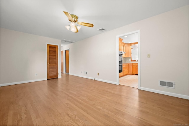 unfurnished room featuring ceiling fan and light wood-type flooring