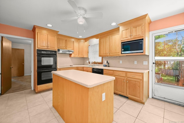 kitchen featuring light brown cabinetry, a kitchen island, ceiling fan, and black appliances