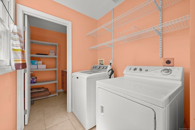 laundry room featuring light tile patterned floors and washer and clothes dryer