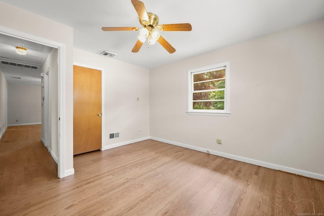 empty room featuring ceiling fan and light wood-type flooring