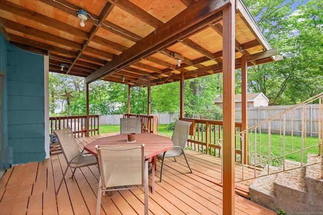 wooden deck with a lawn