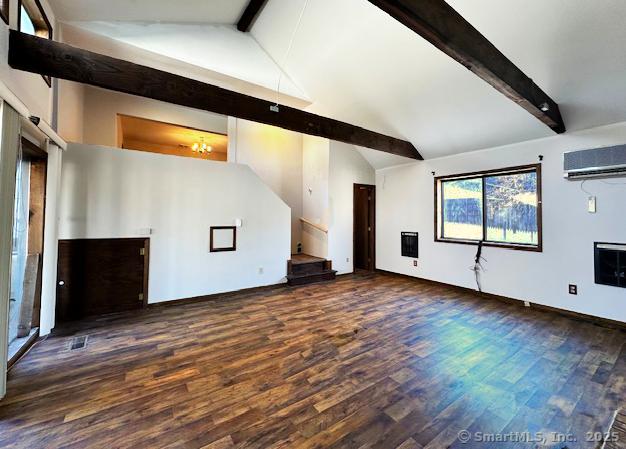 unfurnished living room featuring lofted ceiling with beams, dark wood-type flooring, and a wall mounted AC