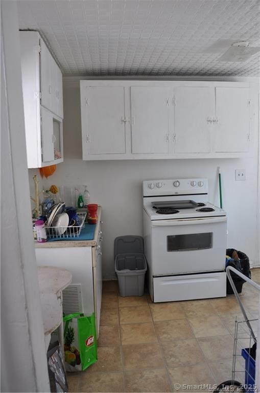 kitchen with white cabinets and white range with electric cooktop