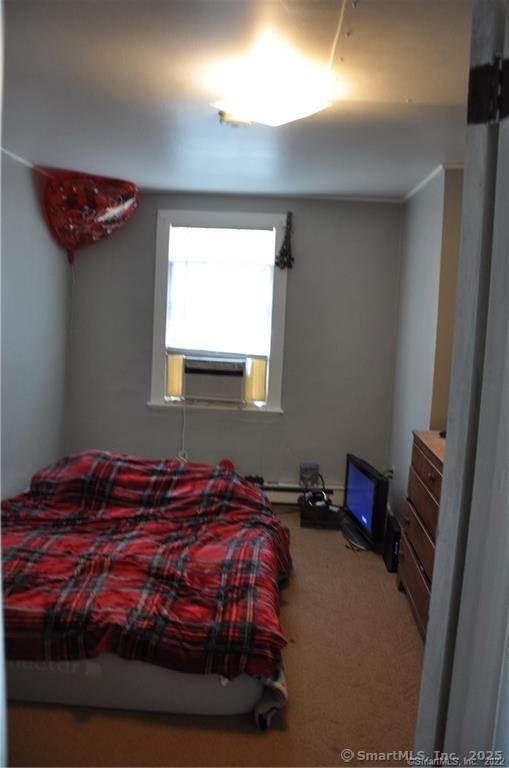 bedroom with carpet and cooling unit