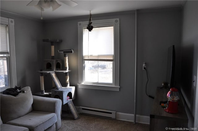 sitting room featuring ceiling fan, carpet, a baseboard radiator, and ornamental molding