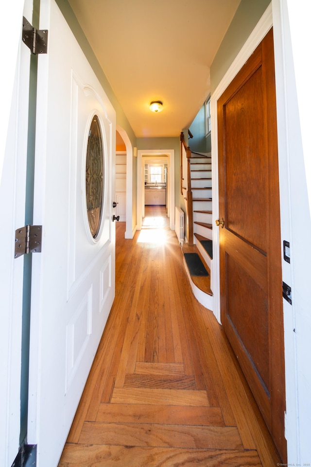 hall featuring light parquet floors and radiator