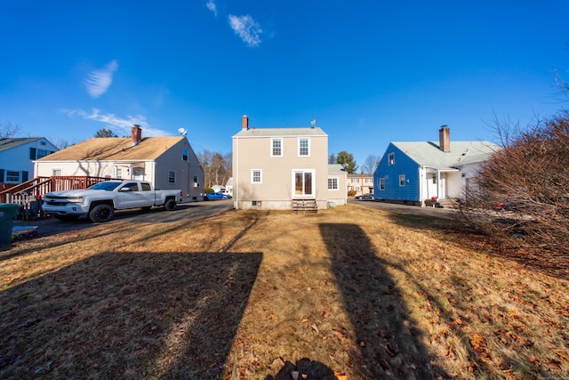 back of house featuring a yard