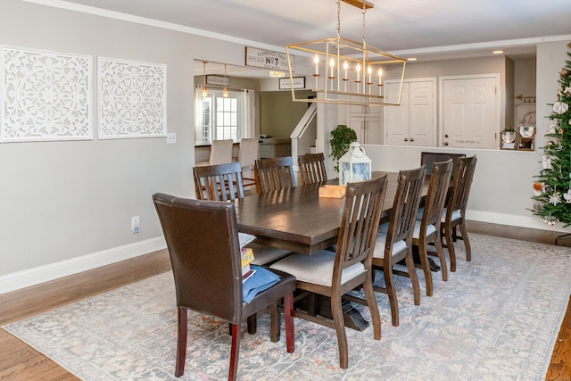 dining area featuring ornamental molding and hardwood / wood-style floors