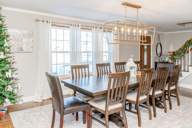 dining area featuring ornamental molding and light wood-type flooring