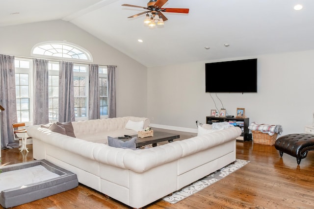 living room featuring lofted ceiling, hardwood / wood-style floors, and ceiling fan