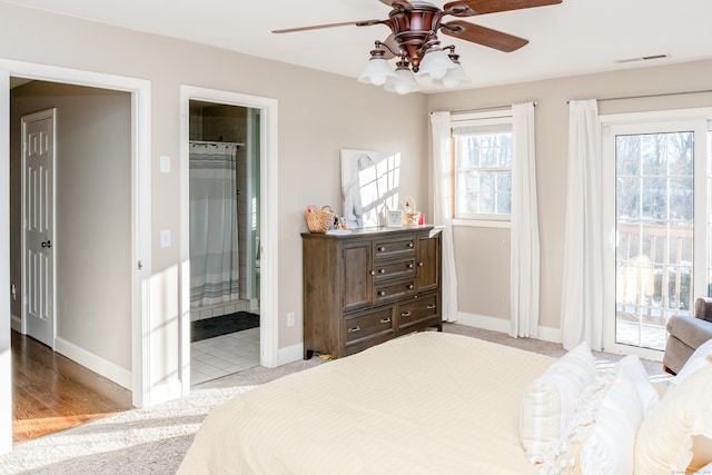 carpeted bedroom featuring connected bathroom, access to outside, and ceiling fan