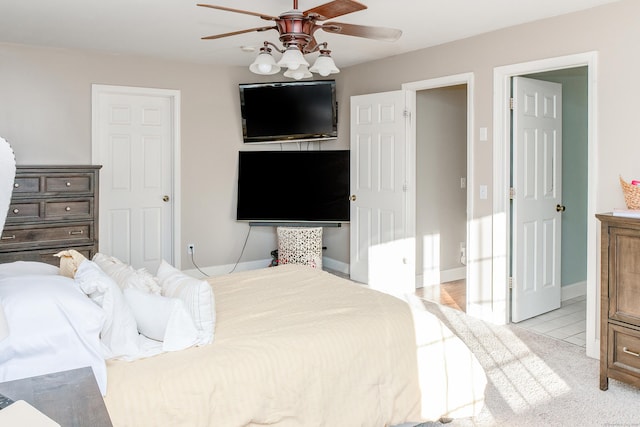 bedroom with ceiling fan and light tile patterned floors