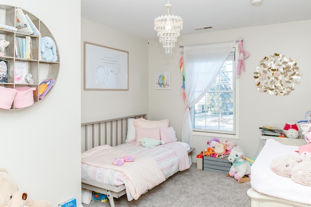 carpeted bedroom featuring an inviting chandelier