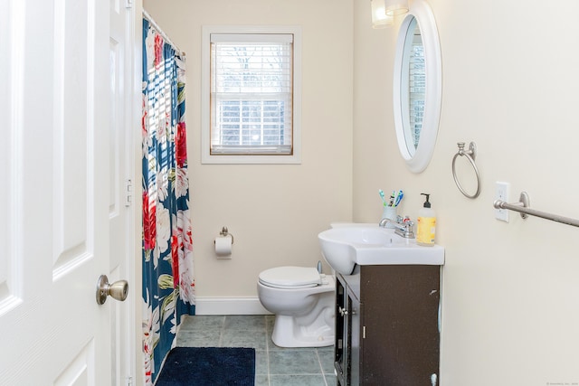 bathroom featuring vanity, tile patterned flooring, and toilet