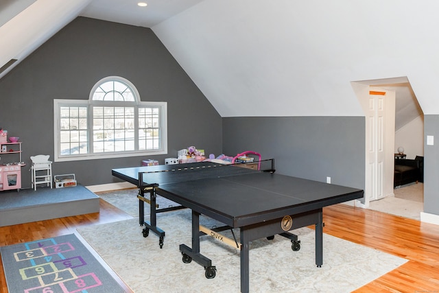 recreation room with vaulted ceiling and hardwood / wood-style floors