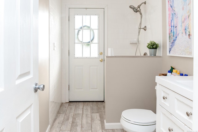 bathroom featuring walk in shower, vanity, toilet, and hardwood / wood-style floors