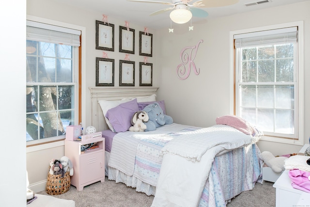 bedroom featuring light colored carpet and ceiling fan