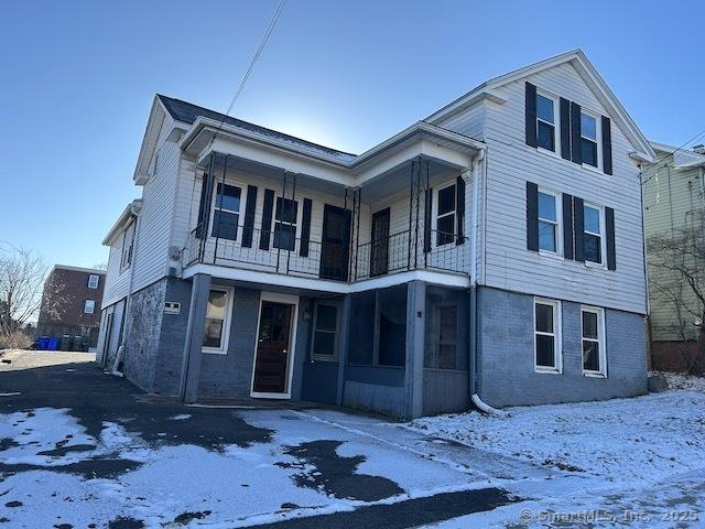 view of front of house featuring a balcony and a garage