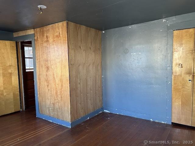 spare room featuring dark hardwood / wood-style flooring