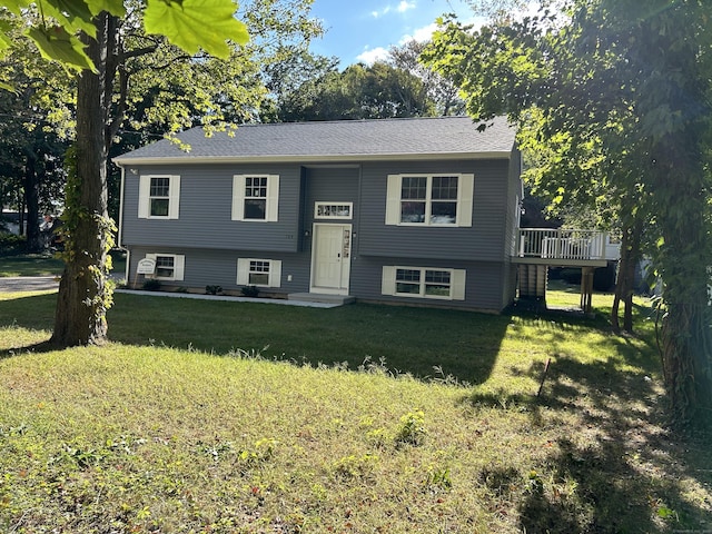 split foyer home with a deck and a front yard