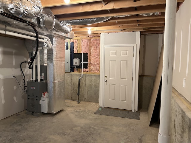 basement with electric panel and heating unit