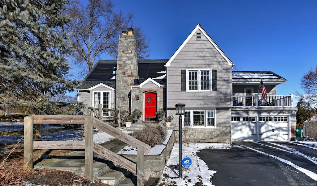 view of front of house with solar panels and a garage