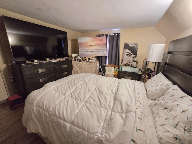 bedroom featuring carpet and vaulted ceiling