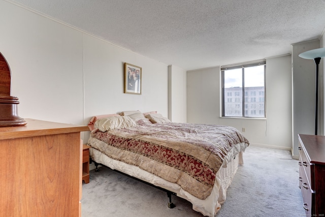 bedroom with carpet and a textured ceiling