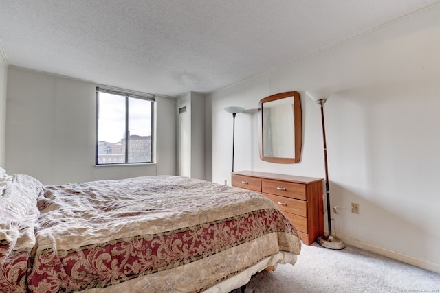 bedroom with carpet floors and a textured ceiling