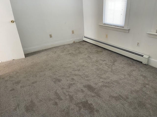 carpeted empty room featuring a baseboard radiator