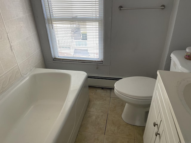 bathroom featuring vanity, a baseboard heating unit, tile patterned floors, toilet, and a tub