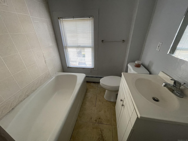 bathroom with vanity, a baseboard heating unit, tile patterned flooring, toilet, and a bathing tub