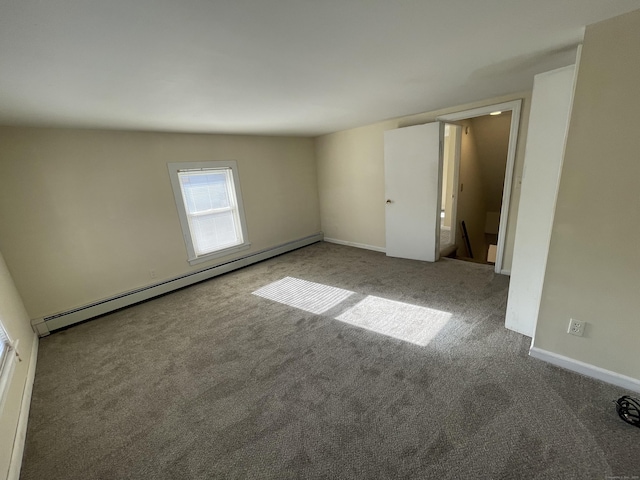 spare room with carpet and baseboard heating