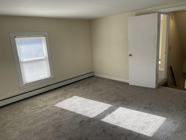 carpeted empty room with a baseboard radiator